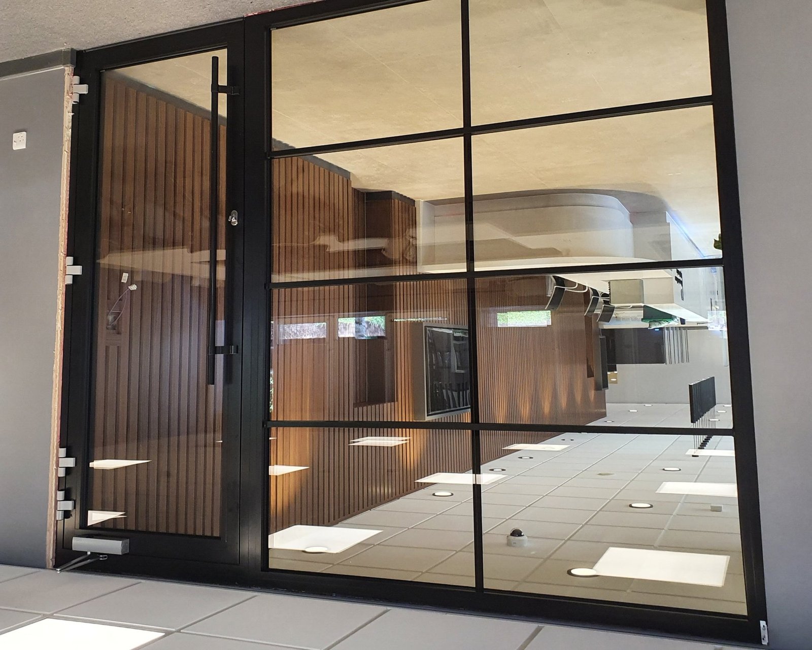 Fire-rated aluminium internal screen with door in an office environment