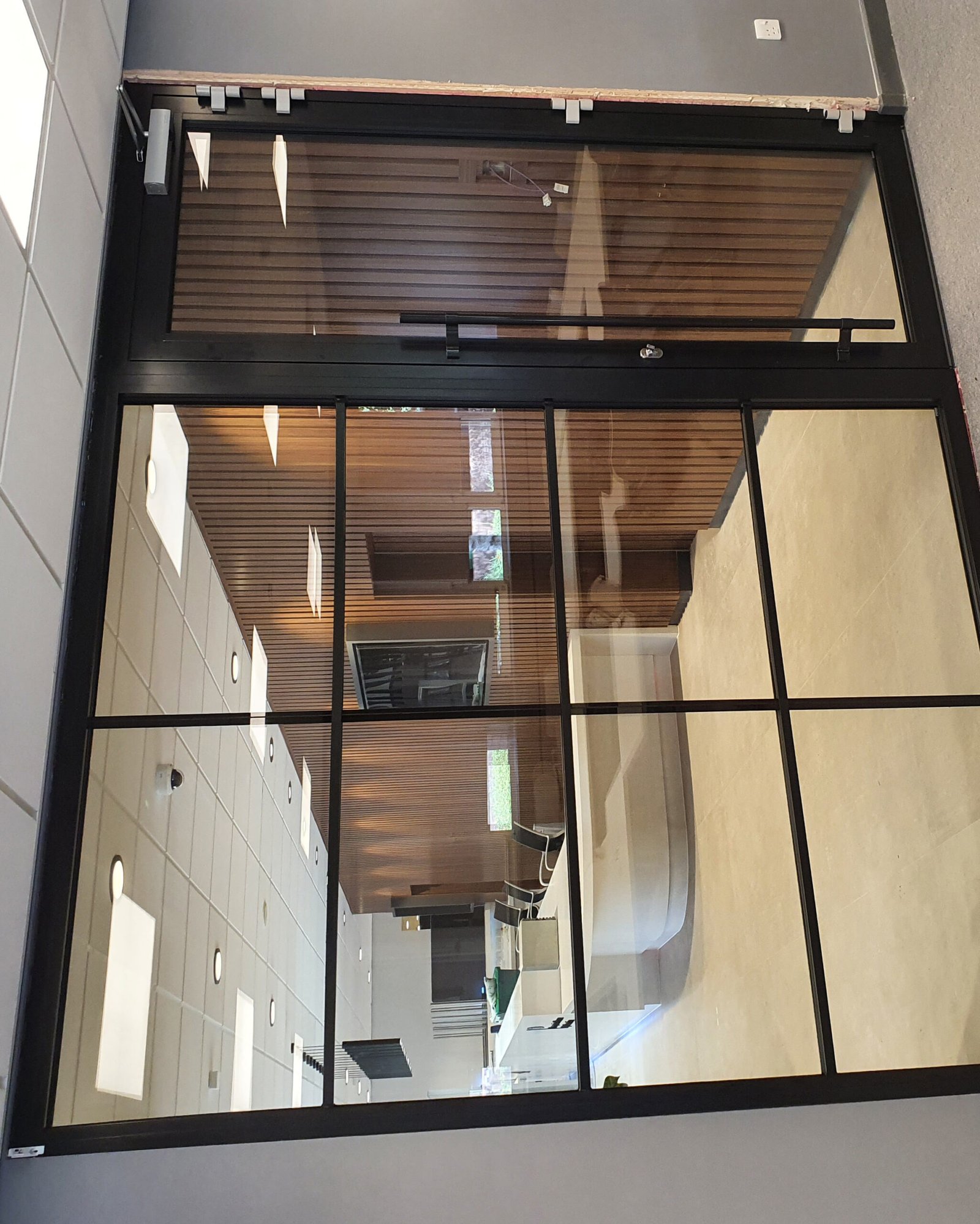 Framed glass partition with door